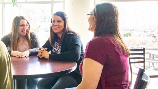 Woman talking with female students